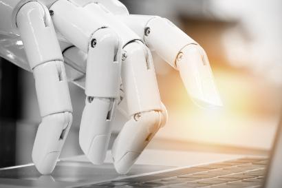 Robot fingers pointing to laptop