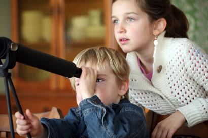 Children looking through a telescope