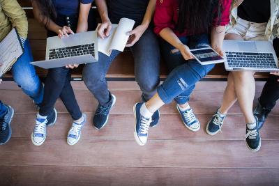 Young people using laptops