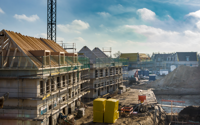 Construction site with half-built houses and scaffolding around them