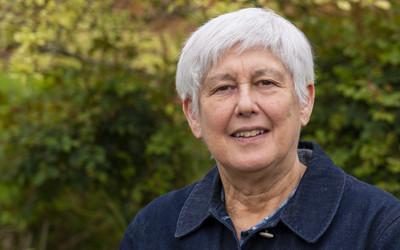 Headshot of Stephanie Taylor with bushes in background