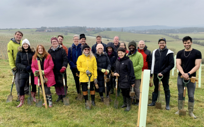 A group of OU research students planting trees.