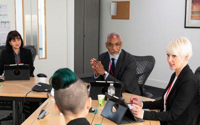 Group of people sitting round a table